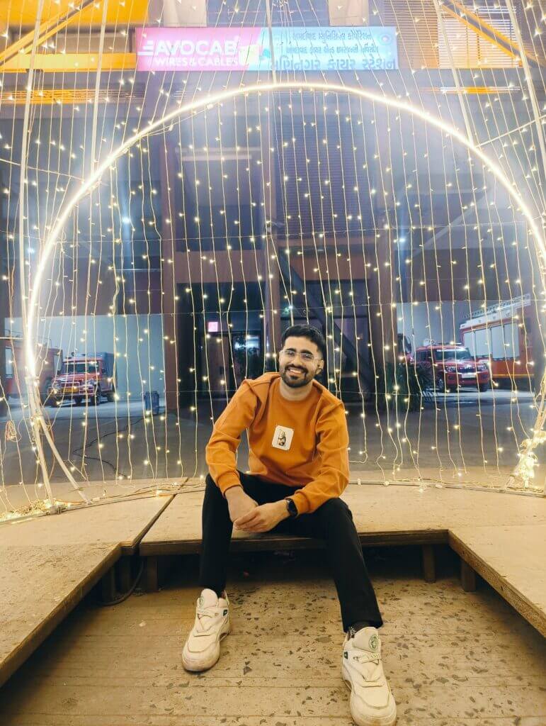 Deep Gopalani smiling joyfully under bright lighting, radiating happiness and positivity.
